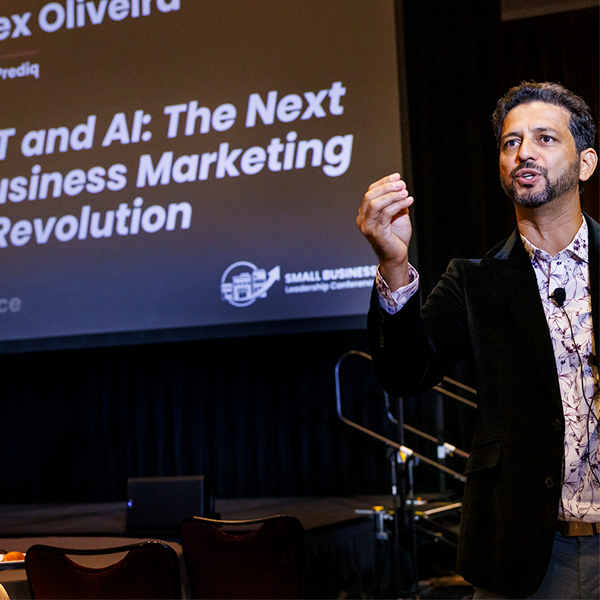 Photo of Alex Oliveira speaking at the Small Business Leadership Conference about AI